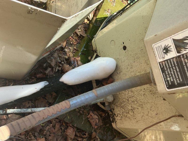 Responded to no cooling complaint on second floor with Nest thermostat calling but temperature not decreasing. Upon arrival, found outdoor condenser unit surrounded by significant debris accumulation including dead leaves and organic matter at base, potentially restricting airflow. Observed furnace dripping water onto floor, indicating condensate drain issue affecting both cooling and heating systems. Performed visual inspection of outdoor unit and documented equipment condition with photos showing debris buildup and condensate drainage concerns. System age unknown at time of inspection. Diagnostic visit completed with findings documented for customer review and recommendation of full system evaluation including condensate drain clearing, outdoor unit cleaning, and airflow verification to restore proper second floor cooling operation.