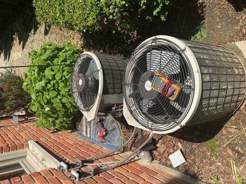 Responded to no cooling complaint on second floor with Nest thermostat calling but temperature not decreasing. Upon arrival, found outdoor condenser unit surrounded by significant debris accumulation including dead leaves and organic matter at base, potentially restricting airflow. Observed furnace dripping water onto floor, indicating condensate drain issue affecting both cooling and heating systems. Performed visual inspection of outdoor unit and documented equipment condition with photos showing debris buildup and condensate drainage concerns. System age unknown at time of inspection. Diagnostic visit completed with findings documented for customer review and recommendation of full system evaluation including condensate drain clearing, outdoor unit cleaning, and airflow verification to restore proper second floor cooling operation.