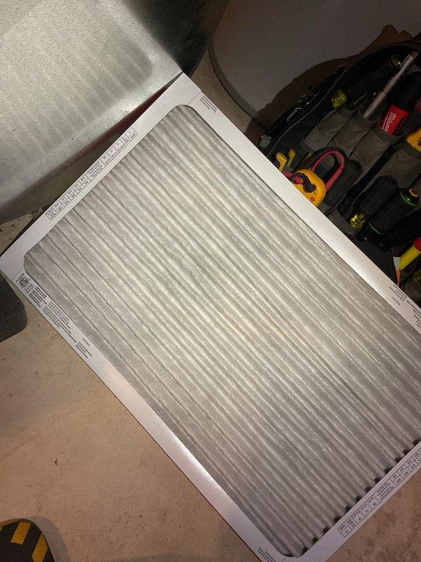 Completed comprehensive Gold AC tune-up inspection on 10-year-old air conditioning system located in basement for new client. Performed full system evaluation including refrigerant level check, electrical component testing, condenser and evaporator coil inspection, and condensate drain line verification. Replaced air filter with new pleated media filter to ensure proper airflow and system efficiency. Inspected all ductwork connections, tested thermostat operation and calibration, and measured temperature differential across coils to verify adequate cooling performance. Cleaned condenser unit, checked amp draw on compressor and blower motor, and tightened all electrical connections. System operating within manufacturer specifications at time of service completion. Discussed Gold Club membership benefits and preventative maintenance program options with client. Documented system condition with photos of water heater installation area and new air filter for service records.