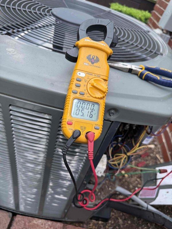 Responded to service call for 16-year-old air conditioning system experiencing inadequate cooling performance. Performed comprehensive diagnostic inspection of outdoor condensing unit with focus on compressor operation and electrical components. Utilized digital clamp meter to measure amperage draw and verify electrical readings at compressor terminals and contactor connections. Accessed unit's electrical compartment to test voltage and current flow through system components. Inspected condenser coil condition, fan motor operation, and overall unit integrity. Documented findings with photographic evidence of electrical measurements and unit condition for customer records and future reference.
