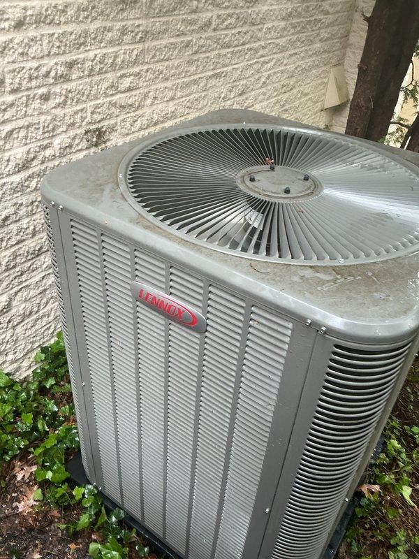 Completed Gold AC inspection on residential property with two Lennox air conditioning systems, both approximately 2 years old. Performed comprehensive multi-point inspection on both outdoor condenser units, checking refrigerant levels, electrical connections, compressor operation, and fan motor performance. Inspected indoor air handler located in basement, verifying proper airflow, drain line functionality, and thermostat operation. Both systems operating within normal parameters with no immediate service needs identified. Documented equipment condition with photographs showing minor accumulation of outdoor debris around condenser units, which is typical for exterior installations. Confirmed with homeowner that both units are functioning properly prior to inspection. All safety controls tested and verified operational on both systems.