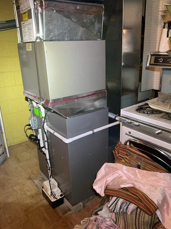 Completed comprehensive Gold AC Inspection on a 10-year-old Carrier air handler unit (Model: CNPVP3621ALAAAAA, Serial: 1320X67034) located in basement. System manufactured March 2020, utilizing R-410A refrigerant with design pressure rated at 450 PSIG. Performed thorough visual inspection of vertically stacked air handler assembly, examined all accessible components including blower compartment, evaporator coil section, and control panel. Verified electrical connections, inspected conduit and junction box mounting, assessed refrigerant line integrity and insulation condition. Documented equipment nameplate data and current operating specifications. Unit confirmed operational by homeowner prior to inspection. All accessible components inspected and photographed for maintenance records.