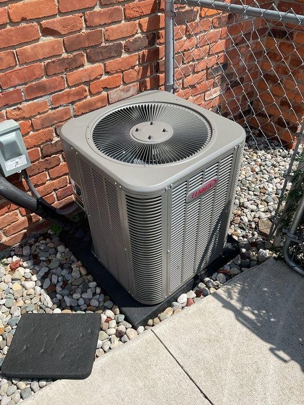 Completed comprehensive Gold AC inspection on 3-year-old single-unit Lennox system with basement-located air handler. Performed full multi-point inspection of outdoor condenser unit positioned on concrete pad with proper clearance and landscaping rock surround, verified operational status of all components including fan motor and coil assembly. Inspected indoor air handler equipped with Aprilaire humidistat control, confirmed proper airflow, checked electrical connections, verified refrigerant levels, cleaned condenser coils, and documented system performance with NADCA certification label present indicating previous maintenance compliance. All equipment found operating within normal parameters with no immediate service needs identified.