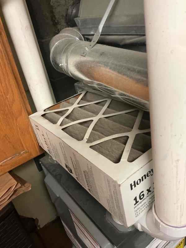 # HVAC Service Completed

Responded to no-cooling complaint on 2-year-old residential air conditioning system. Upon arrival, performed diagnostic assessment of AC unit located adjacent to furnace in basement utility area. 

Inspected thermostat wiring and found improper connections at wall-mounted control. Removed thermostat cover to access terminal block and identified multiple wire connection issues affecting system operation. Corrected wiring configuration at thermostat, ensuring proper connections for R, C, Y, G, and W terminals to restore communication between thermostat and outdoor condensing unit.

Verified air filter condition in supply ductwork—found 16x filter in acceptable condition with no significant blockage affecting airflow. Inspected ductwork connections and confirmed proper sealing at filter housing.

Cycled system through cooling mode to verify proper operation. Confirmed compressor engagement, indoor blower activation, and thermostat responding correctly to temperat