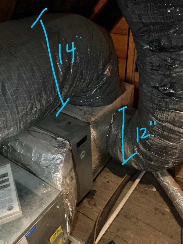 Assessed non-functional 14-year-old Unico HVAC system located in attic space for replacement estimate. Inspected existing air handler unit and associated ductwork configuration, including multiple flexible ducts and cylindrical supply lines measuring 12 and 14 inches in diameter. Documented equipment location, confirmed adequate attic access and working space, and verified air conditioning supply to attic area for comfortable working conditions during future installation.