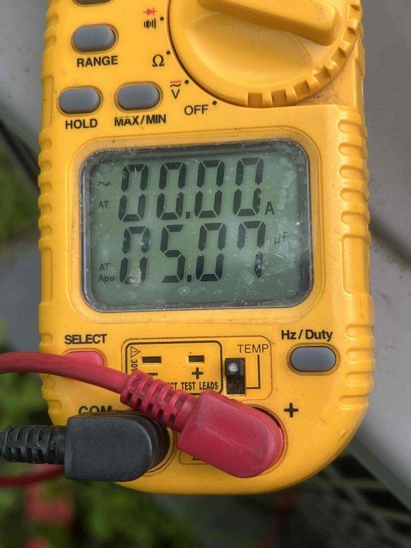 Completed comprehensive Gold AC inspection on 13-year-old residential air conditioning system with furnace-mounted air handler. Performed electrical diagnostics using digital multimeter, recording amperage draw of 95.00A and verifying proper system operation. Inspected outdoor condenser unit, confirming fan assembly, heat exchange coils, and cabinet components are in good working condition with no visible damage or deterioration.