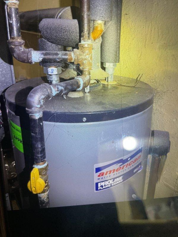 Completed comprehensive Gold AC inspection on 9-year-old residential air conditioning system with air handler located in basement and condensing unit positioned on exterior concrete pad. Performed multi-point inspection including verification of operational status, visual examination of outdoor condenser unit with proper clearance from debris, assessment of electrical disconnect and conduit connections at exterior wall mounting, and inspection of mechanical room equipment. System found operating properly with condenser coils clean, adequate airflow through top-mounted fan assembly, and all components functioning within normal parameters.