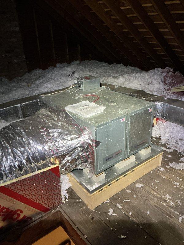 Completed comprehensive Gold AC inspection on 7-year-old attic-mounted space pack system. Unit confirmed operational with thermostat reading 72 degrees. Inspected air handler located in attic space with adequate insulation coverage, verified all connections to flexible ductwork, and assessed overall equipment condition. Advised customer to maintain clear area around outdoor condenser unit, removing any debris and animal waste to ensure optimal system performance and airflow.