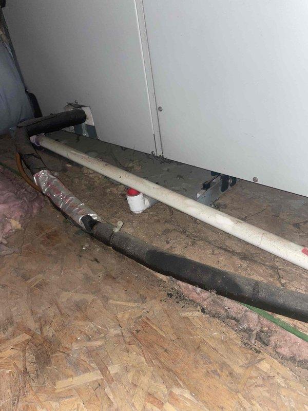 Conducted on-site assessment of existing standalone air conditioning system in preparation for replacement estimate. Inspected attic-mounted air handler unit and associated refrigerant lines, documenting current equipment condition and installation configuration. Photographed existing HVAC components including air handler, refrigerant piping, and ductwork to support replacement proposal for system independent of existing steam boiler heating infrastructure.