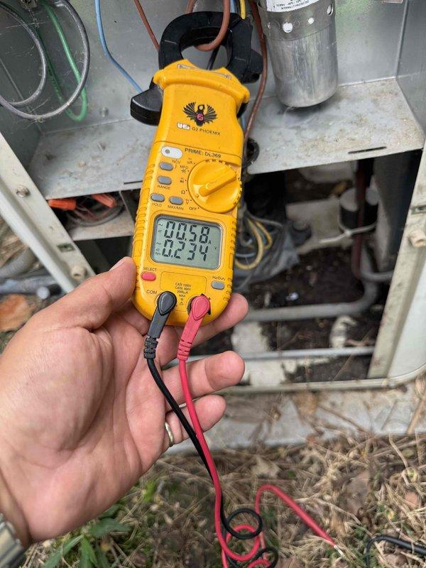 Completed comprehensive Gold AC inspection on 10+ year old air conditioning system with air handler located in basement. Performed electrical diagnostics using clamp meter to verify amperage draws and system performance, inspected outdoor condenser unit on concrete pad, and evaluated overall system operation. Advised customer that area surrounding condenser should be kept clear of debris and animal waste for optimal airflow and system efficiency.