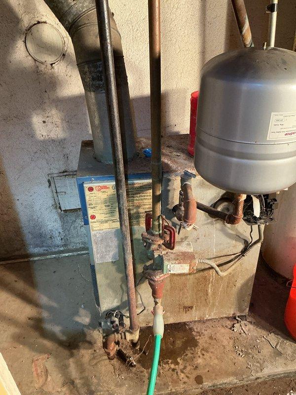 Responded to request for boiler disconnect on approximately 30-year-old unit in basement that was already shut off and locked in place. Coordinated arrival time with property owner as requested. Upon arrival, documented existing conditions of aged heating system including expansion tank, circulator pump, and associated copper piping showing normal wear and corrosion consistent with age. Verified boiler was secured and all connections were in safe condition for disconnect process. Completed photographic documentation of equipment and surrounding utility area prior to disconnect work.