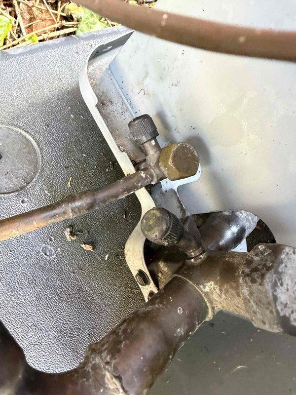 Completed comprehensive Gold AC inspection on single residential unit less than 10 years old with air handler located in attic. Inspected Unico System air handler unit, verifying proper operation and examining all accessible components including refrigerant lines, service valves, and insulated piping. Documented equipment condition through photographic inspection, noting normal weathering and minor surface oxidation on exterior refrigerant line connections and brass service valves. All equipment confirmed operational at time of inspection with no immediate service needs identified.