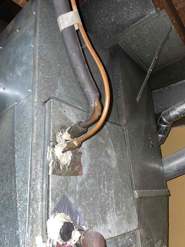 Completed estimate for replacement of existing air conditioning system located in backyard. Inspected current indoor air handler unit with access panel removed to assess internal components, wiring, and mechanical condition. Evaluated ductwork system including main trunk lines and flexible insulated ducting throughout attic space. Observed moisture accumulation on metal ductwork surfaces indicating condensation issues that should be addressed during replacement installation.