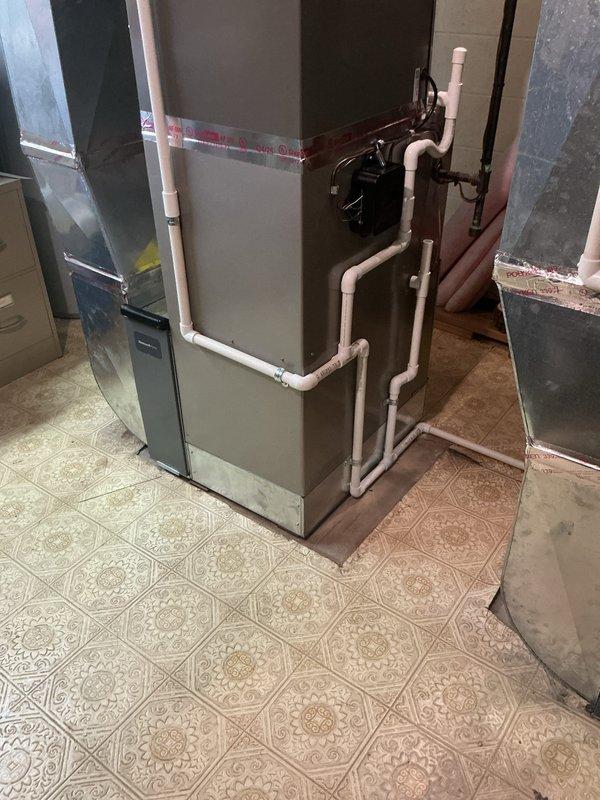 Successfully completed installation of 3.5-ton and 3-ton air conditioning systems with matching evaporator coils at a multi-unit property. Installed new air handler units in the mechanical room with proper condensate drain lines using white PVC piping, including drainage pump installation. Completed all mechanical and electrical connections, verified proper refrigerant line connections to rear-discharge outdoor units, and ensured all ductwork transitions were properly sealed and secured. System tested and operational upon completion.