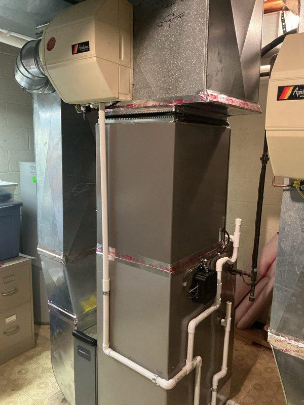 Successfully completed installation of 3.5-ton and 3-ton air conditioning systems with matching evaporator coils at a multi-unit property. Installed new air handler units in the mechanical room with proper condensate drain lines using white PVC piping, including drainage pump installation. Completed all mechanical and electrical connections, verified proper refrigerant line connections to rear-discharge outdoor units, and ensured all ductwork transitions were properly sealed and secured. System tested and operational upon completion.