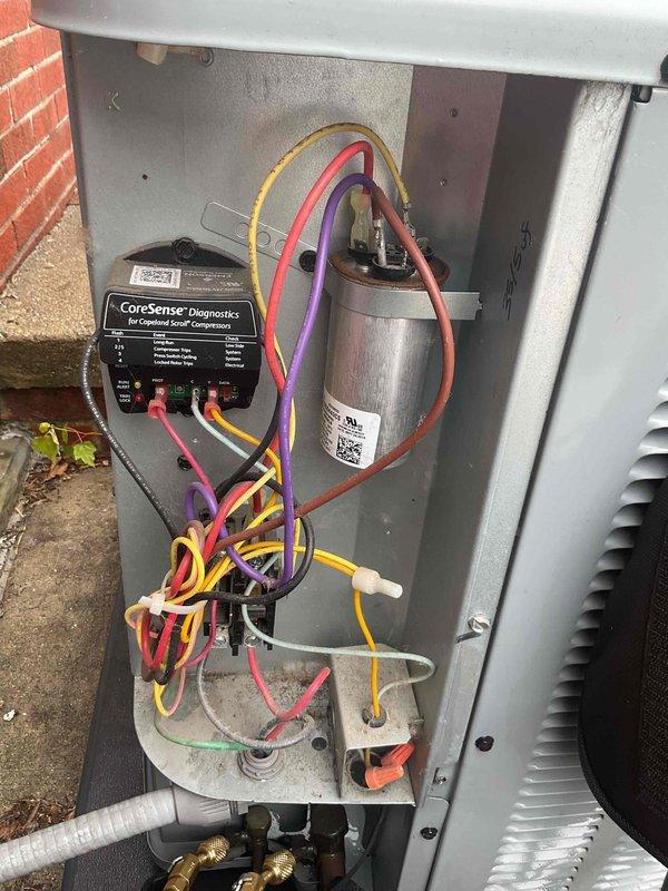 # HVAC Maintenance - Gold AC Inspection

Completed comprehensive Gold-level air conditioning inspection on Daikin model DV13AA03IAF outdoor condensing unit. Performed visual assessment of all electrical components including capacitor connections with multiple conductor wires (yellow, red, purple, pink) verified for secure terminal attachment. Installed and utilized CorSense diagnostic device to evaluate system performance and comfort control parameters. Inspected metal housing integrity, noting normal weathering consistent with outdoor installation. Verified proper operation of all electrical connections and components within the unit enclosure. Examined manufacturer labeling and certification marks confirming unit specifications and compliance. Assessed refrigerant line connections including brass valve fittings and associated piping. Documented unit condition through photographic evidence showing internal components and external installation details. All systems found operational wit