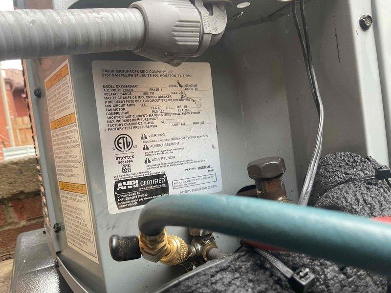 # HVAC Maintenance - Gold AC Inspection

Completed comprehensive Gold-level air conditioning inspection on Daikin model DV13AA03IAF outdoor condensing unit. Performed visual assessment of all electrical components including capacitor connections with multiple conductor wires (yellow, red, purple, pink) verified for secure terminal attachment. Installed and utilized CorSense diagnostic device to evaluate system performance and comfort control parameters. Inspected metal housing integrity, noting normal weathering consistent with outdoor installation. Verified proper operation of all electrical connections and components within the unit enclosure. Examined manufacturer labeling and certification marks confirming unit specifications and compliance. Assessed refrigerant line connections including brass valve fittings and associated piping. Documented unit condition through photographic evidence showing internal components and external installation details. All systems found operational wit
