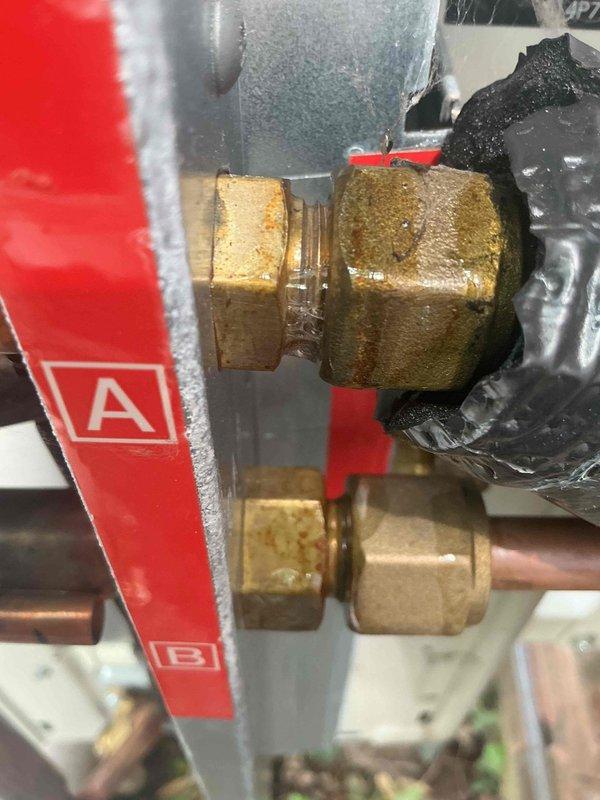 Responded to service call for mini-split system displaying A5 error code (high pressure control/freeze up protector) with intermittent operation on 1-year-old dual-zone system serving living room and master bedroom. Upon arrival, performed diagnostic testing using refrigerant leak detection equipment on outdoor unit and line set connections. Inspected electrical disconnect panel and found evidence of corrosion on copper busbars and electrical connections. Examined refrigerant line compression fittings and brass connections for proper installation and potential leak points. Measured and documented refrigerant line assembly at connection points. Testing revealed compromised electrical connections contributing to intermittent high-pressure faults. Cleaned corroded electrical components, verified proper voltage supply, and ensured secure connections at outdoor unit disconnect. Inspected both indoor units for airflow restrictions and proper operation. System tested successfully with error c