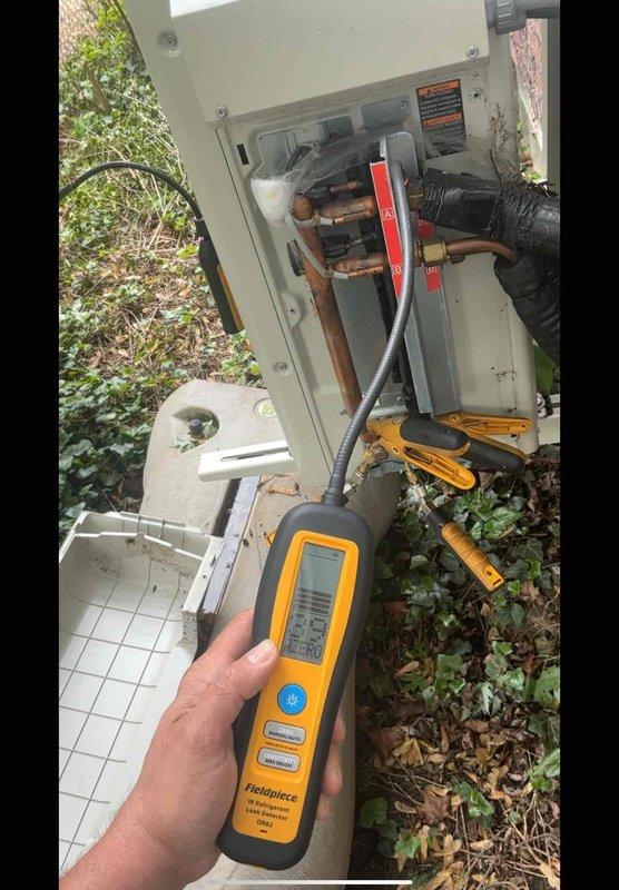 Responded to service call for mini-split system displaying A5 error code (high pressure control/freeze up protector) with intermittent operation on 1-year-old dual-zone system serving living room and master bedroom. Upon arrival, performed diagnostic testing using refrigerant leak detection equipment on outdoor unit and line set connections. Inspected electrical disconnect panel and found evidence of corrosion on copper busbars and electrical connections. Examined refrigerant line compression fittings and brass connections for proper installation and potential leak points. Measured and documented refrigerant line assembly at connection points. Testing revealed compromised electrical connections contributing to intermittent high-pressure faults. Cleaned corroded electrical components, verified proper voltage supply, and ensured secure connections at outdoor unit disconnect. Inspected both indoor units for airflow restrictions and proper operation. System tested successfully with error c