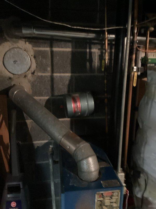 Responded to service call for boiler system with overheating motor. Conducted thorough inspection of blue boiler unit and associated components in basement mechanical room, including examination of circulator pump motor, piping connections, copper supply lines, and PVC venting system. Documented equipment condition with photographs showing complete installation setup, pipe configuration, and mechanical components for estimate preparation, as unit requires quotation for necessary repairs or replacement.