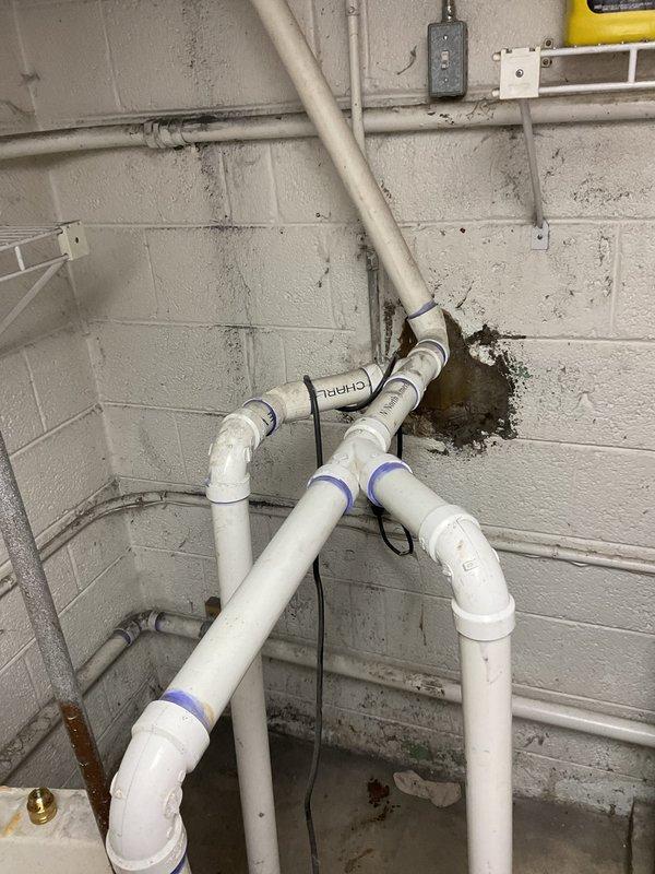 Responded to a plumbing service call at a 76-year-old residential property requiring water pipe capping in the basement. Upon arrival, inspected the basement utility area containing a sump pump pit system with multiple exposed PVC and metal pipes that had been left uncapped for an extended period. The work area included white PVC drainage lines, rusted metal piping, and various plumbing connections around the sump pit with visible water damage and moisture staining on surrounding surfaces.

Successfully capped all exposed water pipes in the basement to prevent water flow and potential flooding. Work focused on securing open pipe ends with appropriate caps and fittings to ensure proper water shutoff. The installation addressed immediate concerns related to the uncapped pipes that posed risks of water damage and system inefficiency. All capping work was completed using industry-standard materials compatible with the existing PVC and metal pipe infrastructure present in the 1950s-era home