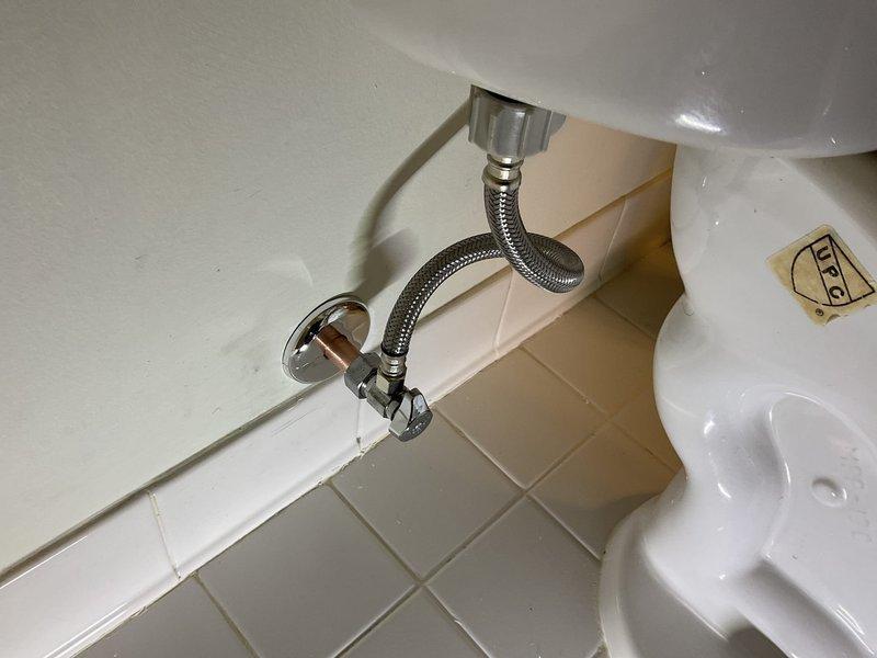 Responded to primary bedroom bathroom for leaking toilet shut-off valve that began leaking black water after homeowner turned off water supply to perform tank cleaning. Inspected toilet tank interior and identified deteriorated valve components causing continuous seepage. Replaced three shut-off valves in bathroom including the problematic toilet supply valve with new chrome angle stops and installed new braided stainless steel supply lines. Tested all connections for leaks, verified proper water flow and pressure, and confirmed all fixtures operating correctly with no further water seepage.