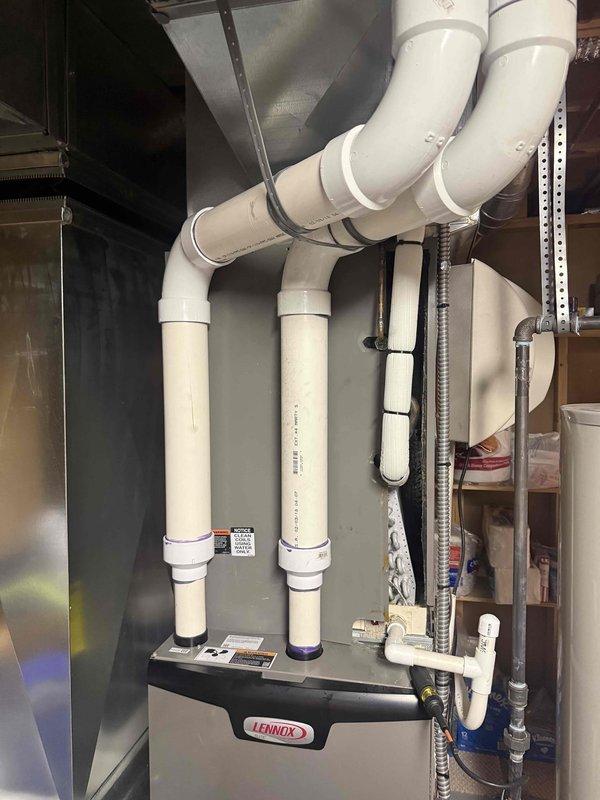 Responded to service call for Lennox 13ACXN060-230 central air conditioning system installed in April 2018 with inadequate cooling performance. Upon inspection, discovered severely corroded evaporator coil with extensive oxidation on copper refrigerant tubes and U-bend connections. The deteriorated condition of the coil assembly was determined to be the primary cause of reduced cooling capacity. Documented existing equipment condition including furnace, ductwork, and PVC venting system. Evaporator coil replacement required and has been ordered under purchase order 1324783-001 for installation to restore proper system operation and cooling efficiency.