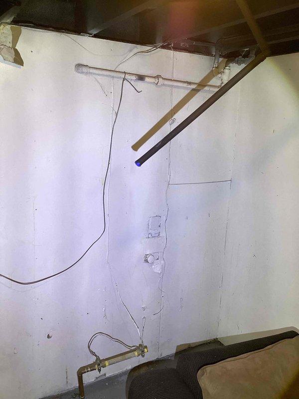 Provided estimate for replacement of non-functional 30-gallon electric water heater located in basement. Unit age unknown; existing installation shows signs of moisture exposure in surrounding area with visible water staining on walls and condensation present on nearby ductwork, indicating potential previous leakage or humidity issues that should be addressed during replacement.