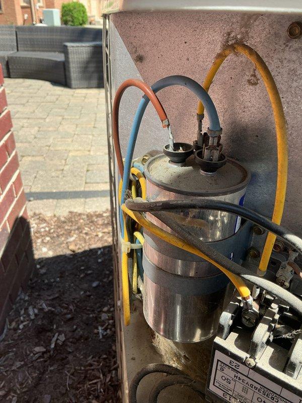 Responded to water leak complaint on 6-year-old air conditioning system located in basement. Upon inspection, unit was operational and maintaining cooling capacity. Examined indoor evaporator coil assembly and condensate drainage system for source of water leak. Inspected outdoor condenser unit components including compressor, refrigerant lines, and electrical connections. Checked condensate drain line routing from basement unit to exterior discharge point. Verified proper drainage flow and cleared any blockages in condensate system. Inspected refrigerant line insulation for condensation issues. All refrigerant connections showed normal operating condition with no signs of refrigerant leakage. System tested and confirmed operational with proper cooling performance restored.