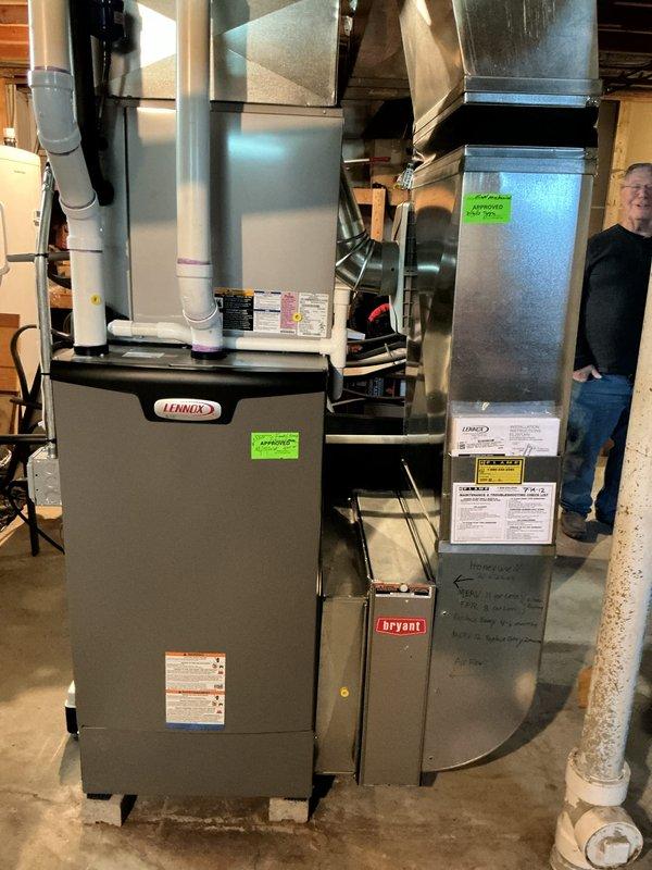 Conducted comprehensive evaluation of 14-year-old residential air conditioning system experiencing multiple failure indicators. Identified active refrigerant leak, severely pitted contactor showing signs of electrical arcing, and compressor exhibiting abnormal noise during startup and shutdown cycles indicating internal mechanical wear. Documented existing Lennox air handler installation in basement with associated ductwork and drainage systems. Prepared replacement estimate for complete HVAC system upgrade, noting that outdoor condenser pad area requires clearance of debris and animal waste prior to installation. Verified current system operational status and photographed equipment configuration including furnace, air handler, ductwork connections, and PVC condensate drainage lines for replacement planning purposes.