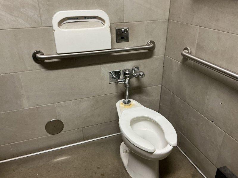 Responded to commercial facility for reported dripping faucet issues in men's restroom adjacent to room 103. Upon arrival, inspected plumbing fixtures in multiple restroom stalls including standard and ADA-accessible facilities. Examined chrome flush valves, exposed piping connections, and wall-mounted fixtures for leaks or malfunction. Addressed dripping conditions at affected faucet locations, performed necessary repairs to restore proper operation and eliminate water waste. All fixtures tested and verified operational upon completion.