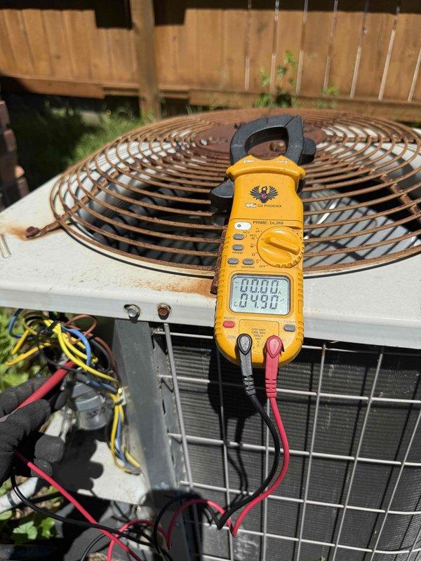 Responded to no cooling complaint on 14-year-old residential air conditioning system. Upon arrival, performed diagnostic testing on both indoor blower motor assembly located in basement and outdoor condensing unit. Utilized digital clamp meter to measure electrical draw and verify proper voltage supply to compressor and condenser fan motor. Inspected blower motor electrical connections and terminals, confirming wire integrity and secure connections at motor capacitor. Evaluated outdoor unit for proper operation, checking refrigerant pressures and amperage draw on compressor. System restored to normal cooling operation following diagnostic procedures and minor adjustments to electrical connections.