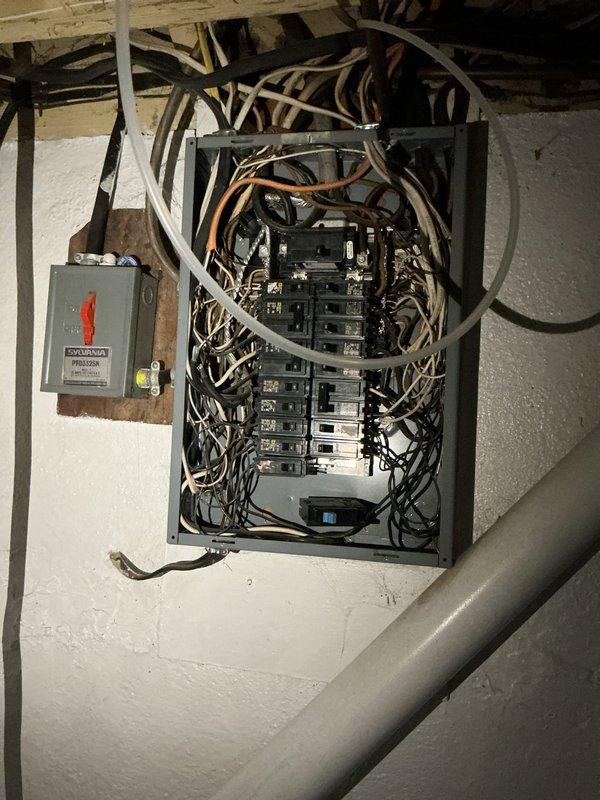 Responded to emergency service call for sparks originating from main electrical panel. Upon inspection, identified hazardous wiring conditions including disorganized conductor management above panel box and potential loose connections causing arcing. Secured all wire terminations at breakers and bus bars, reorganized conductor routing to eliminate strain on connections, and verified proper torque specifications on all termination points. Tested all circuits for proper voltage and confirmed safe operating conditions before restoring full power to residence.