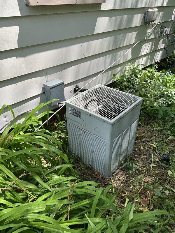 Conducted on-site evaluation of a non-functioning 12-year-old residential air conditioning system for replacement estimate. Assessed existing outdoor condensing unit positioned on side of home, documented current equipment condition and installation location including electrical disconnect and service access. Provided comprehensive replacement options for whole-house cooling system based on equipment age and operational failure.