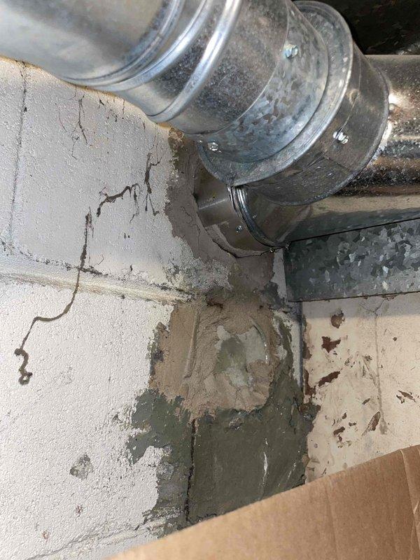 Conducted comprehensive site assessment for full HVAC system replacement including central air conditioning and furnace. Inspected existing ductwork infrastructure in basement utility area, noting galvanized metal supply ducts with cylindrical connection joints and mounting hardware. Documented current installation conditions including foundation wall integrity, floor conditions, and existing duct routing for proper equipment sizing and placement planning. Photographed installation area to capture structural considerations and clearance requirements for new equipment placement. Provided detailed quote for complete system replacement.