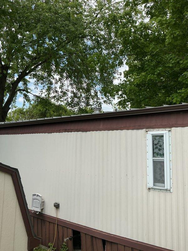 Successfully installed a Bradford White tanked water heater in a mobile home utility closet with proper venting through vertical exhaust pipe. Connected copper supply lines and ensured all connections were secure and code-compliant for residential manufactured home application.