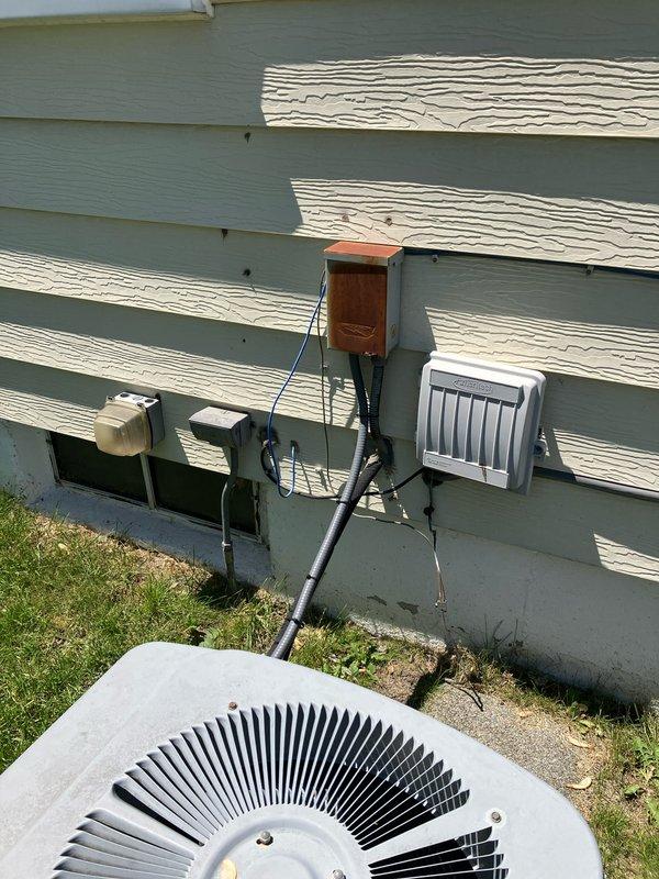 Provided estimate for complete HVAC system replacement including air conditioning unit and natural gas furnace for 21-year-old equipment located in basement. Current air conditioner is non-operational while furnace remains functional. Evaluated existing outdoor condenser unit with visible wear and aging components, assessed electrical disconnect box and associated wiring connections, and documented current system configuration including wall-mounted electrical components and conduit routing.