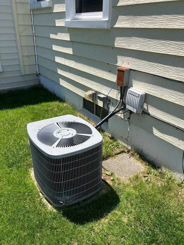 Provided estimate for complete HVAC system replacement including air conditioning unit and natural gas furnace for 21-year-old equipment located in basement. Current air conditioner is non-operational while furnace remains functional. Evaluated existing outdoor condenser unit with visible wear and aging components, assessed electrical disconnect box and associated wiring connections, and documented current system configuration including wall-mounted electrical components and conduit routing.