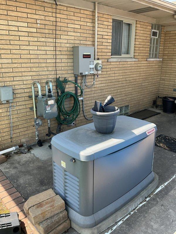 Completed Gold AC Inspection on 10+ year old residential air conditioning system with air handler/coil located in basement. Performed comprehensive system evaluation including visual inspection of outdoor condensing unit, electrical disconnect components, and associated equipment. Noted exterior electrical enclosure showing significant weathering and rust corrosion on metal housing and interior back panel, though functional components remain operational. Advised customer that area surrounding condenser unit requires clearing of debris and any animal waste to maintain proper airflow and system efficiency. Verified system operational status and documented equipment condition through photographic records. All inspection protocols completed per Gold maintenance program standards.