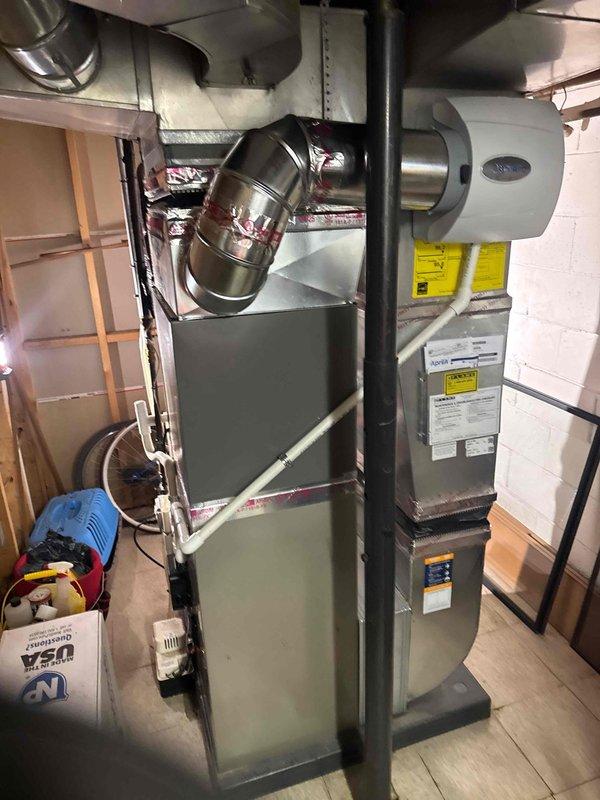 Completed full HVAC system installation in basement mechanical room including 2-ton air conditioning unit with evaporator coil, furnace, and humidifier. Installed all ductwork connections with proper metallic flexible and rigid duct components, ensuring secure transitions and professional routing throughout the space. Performed electrical reconnection, system flush, and obtained mechanical and electrical permits as required. All equipment mounted, labeled, and tested for proper operation with system ready for service.