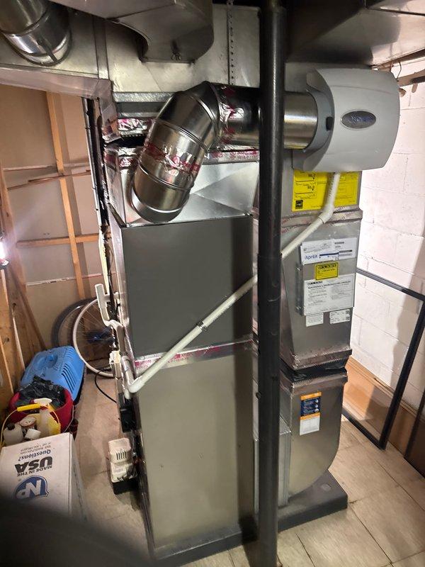 Completed full HVAC system installation in basement mechanical room including 2-ton air conditioning unit with evaporator coil, furnace, and humidifier. Installed all ductwork connections with proper metallic flexible and rigid duct components, ensuring secure transitions and professional routing throughout the space. Performed electrical reconnection, system flush, and obtained mechanical and electrical permits as required. All equipment mounted, labeled, and tested for proper operation with system ready for service.