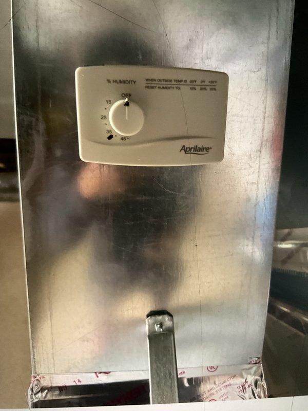 Completed comprehensive Gold AC inspection on 12-year-old residential cooling system with air handler located in basement. Performed thorough evaluation of outdoor condensing unit positioned on concrete pad, confirming proper operation of compressor, condenser fan motor, and electrical components. Inspected indoor air handler and evaporator coil assembly in basement, including Aprilaire humidifier control mounted on main supply duct. Verified refrigerant pressures, checked electrical connections, measured temperature differential across coil, and assessed overall system performance. Unit operating within manufacturer specifications with no immediate service needs identified at time of inspection.