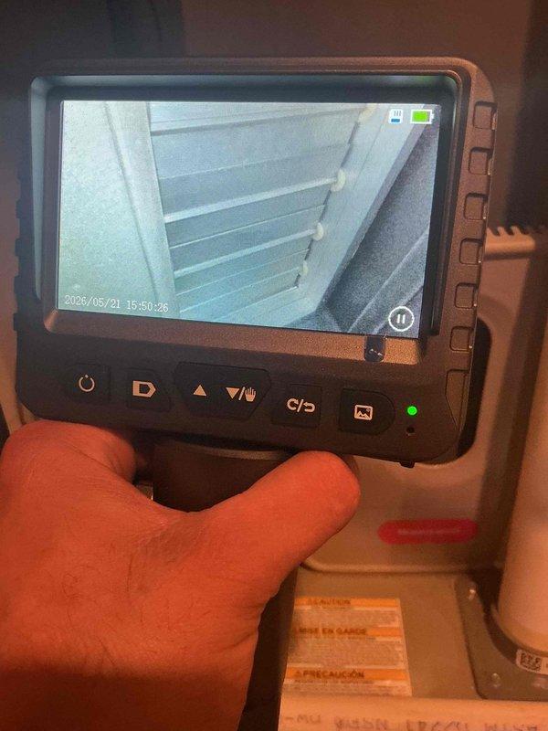 Responded to callback for persistent whistling noise in furnace following previous service where caulking was applied. Performed visual inspection of furnace components and ductwork using borescope camera to identify source of whistling. Inspected floor register and supply ductwork for air leaks or restrictions that could cause noise issues. Documented findings with inspection camera showing interior duct conditions and heat exchanger components to determine if additional sealing or adjustments are required to resolve the whistling concern.