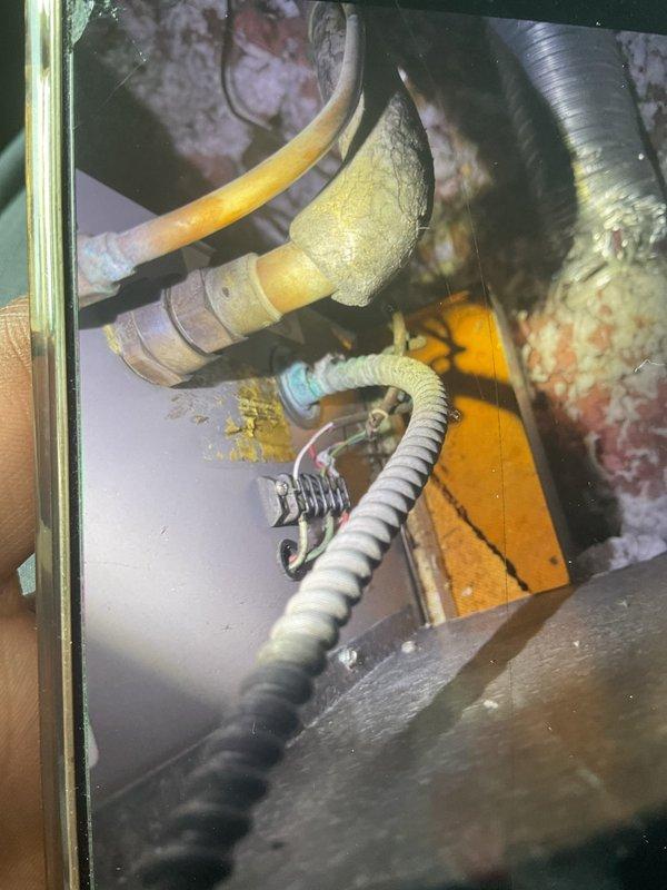 Responded to service call for 10-year-old air conditioning system located in attic with reports of no cooling and active water leak. Upon arrival, accessed equipment in extremely confined attic space with limited clearance. Inspected condensate drain system and identified clogged drain line causing water backup and overflow. Cleared obstruction from drain line and verified proper drainage flow. Examined evaporator coil area and surrounding components for additional leak sources. Tested system operation after repairs and confirmed unit cooling properly with no active leaks present. Verified all electrical connections secure and control unit functioning correctly.