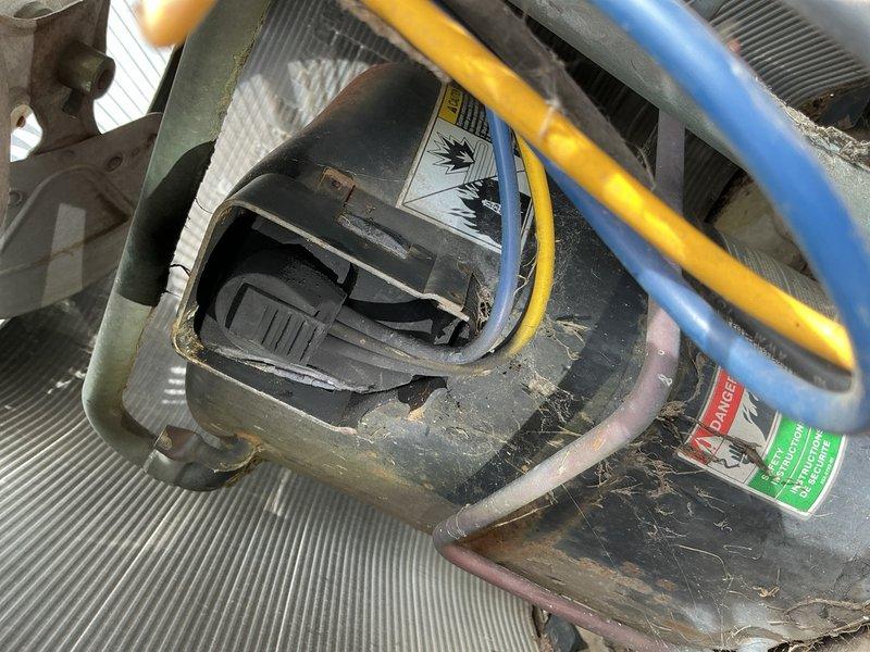 Responded to no cooling complaint on residential air conditioning system over 10 years old located in basement. Upon arrival, confirmed unit was running but delivering warm air to living space. Performed visual inspection of outdoor condensing unit, noting accumulated debris and environmental wear consistent with age of equipment. Accessed electrical compartment and utilized digital multimeter to test voltage and electrical connections at control board and compressor circuit. Identified electrical fault preventing compressor operation. Traced wiring through control panel, checking capacitor, contactor, and associated components. Found failed contactor preventing power delivery to compressor. Replaced defective contactor with appropriate replacement part. Verified proper voltage readings across all circuits and confirmed compressor engagement. Tested system operation through complete cooling cycle. Unit achieved proper temperature differential and returned to normal cooling operation. C