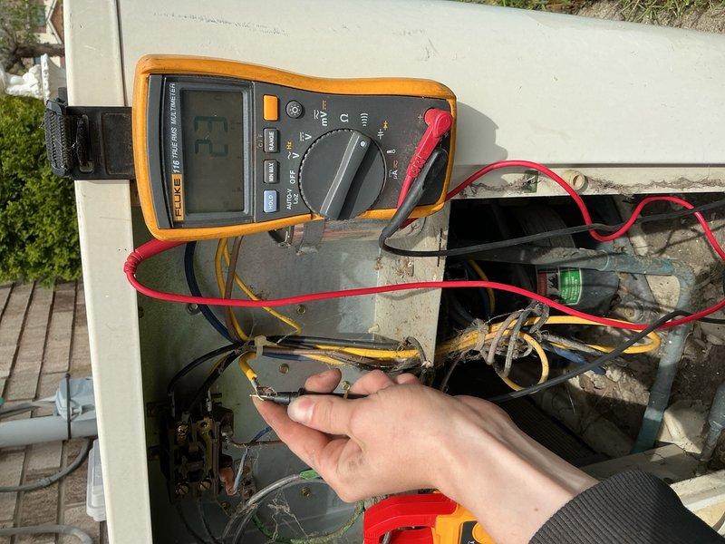 Responded to no cooling complaint on residential air conditioning system over 10 years old located in basement. Upon arrival, confirmed unit was running but delivering warm air to living space. Performed visual inspection of outdoor condensing unit, noting accumulated debris and environmental wear consistent with age of equipment. Accessed electrical compartment and utilized digital multimeter to test voltage and electrical connections at control board and compressor circuit. Identified electrical fault preventing compressor operation. Traced wiring through control panel, checking capacitor, contactor, and associated components. Found failed contactor preventing power delivery to compressor. Replaced defective contactor with appropriate replacement part. Verified proper voltage readings across all circuits and confirmed compressor engagement. Tested system operation through complete cooling cycle. Unit achieved proper temperature differential and returned to normal cooling operation. C