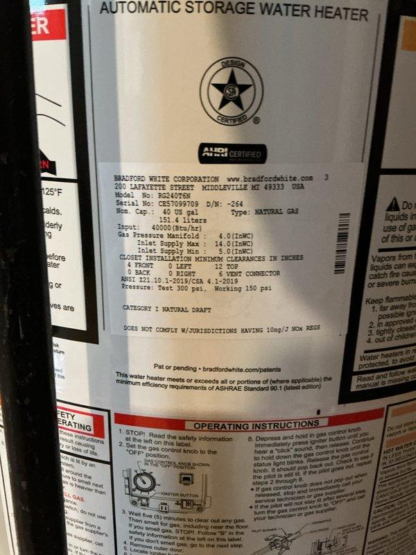 Replaced failed water heater with new 40-gallon Bradford White natural draft unit in basement utility area. Removed existing water heater, installed new unit with proper copper supply and discharge piping connections, installed code-compliant temperature and pressure relief valve with discharge line, and connected natural gas supply with flexible connector. Verified proper venting configuration, tested all connections for leaks, filled tank, ignited pilot light, and confirmed unit operational. Inspected 11-year-old furnace as requested and addressed water accumulation issue on basement floor in vicinity of mechanical equipment.