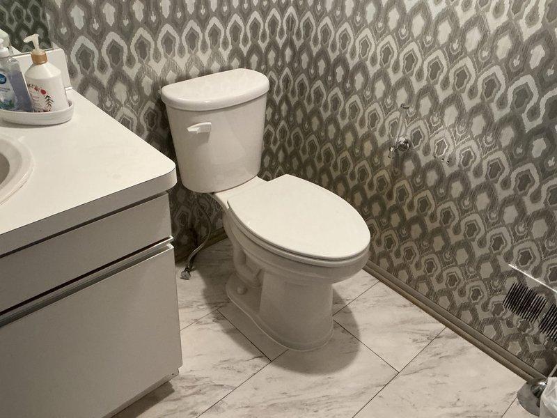 Replaced first floor lowboy toilet with new unit featuring wooden seat and installed new toilet stop valve. Rebuilt second floor toilet with new fill valve, flapper, and flush lever to restore proper operation. Swapped plastic seat on recently installed second floor toilet with wooden seat per specification.