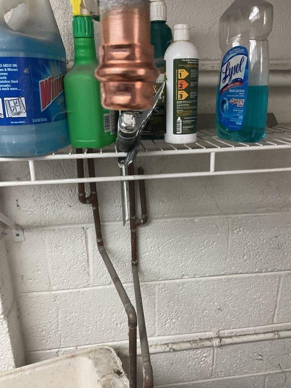 Completed plumbing repair in basement utility area addressing water intrusion and drainage issues. Repaired and secured white PVC piping system along concrete block walls, replacing damaged sections and properly fastening with mounting straps. Remediated standing water on concrete floor, identified source of leak at wall penetration point, and sealed damaged wall opening where pipe enters structure to prevent future water accumulation.