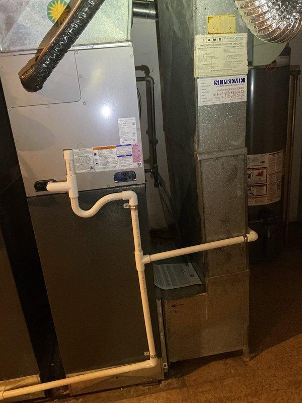 Responded to no cooling call on recently installed downstairs air conditioning system that would not turn on. Upon arrival, inspected residential HVAC installation in basement consisting of furnace and air handler with associated ductwork and PVC condensate piping. Investigated electrical panel labeled "Panel B" and reviewed circuit assignments for both upstairs and downstairs AC units. Identified circuit breaker issue affecting downstairs air conditioning unit power supply. Reset tripped breaker on circuit serving downstairs AC system and verified proper electrical connection to equipment. Tested system operation and confirmed downstairs air conditioning unit powered on successfully and began cooling cycle. System returned to normal operation with proper airflow through ductwork and equipment functioning as designed.